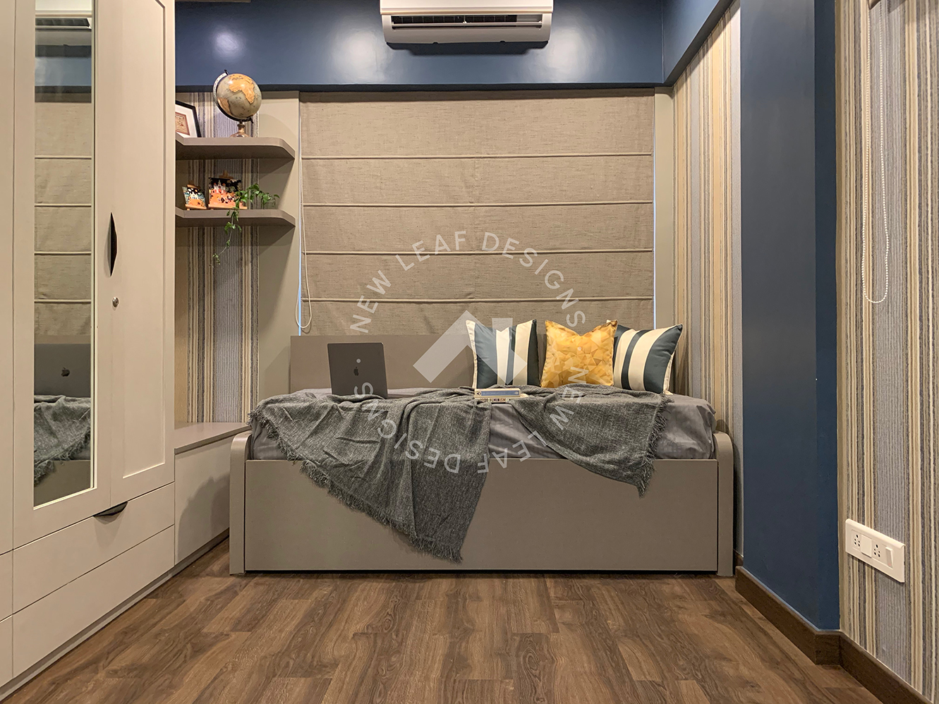 Compact kids bedroom design with sofa-cum-bed, blue walls, custom toy storage and display, striped wallpaper and wooden PVC flooring