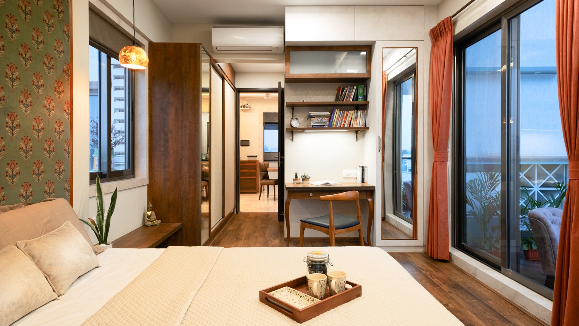 Contemporary bedroom interior design in Pune featuring custom wardrobe, study unit, wood finishes, soft lighting, and functional space planning