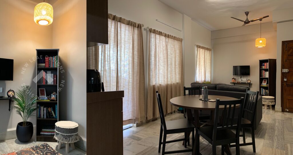 Indian rental apartment living–dining space showing how furniture layout, lighting and soft furnishings improve comfort without permanent changes.